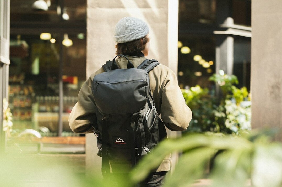 man with backpack in store